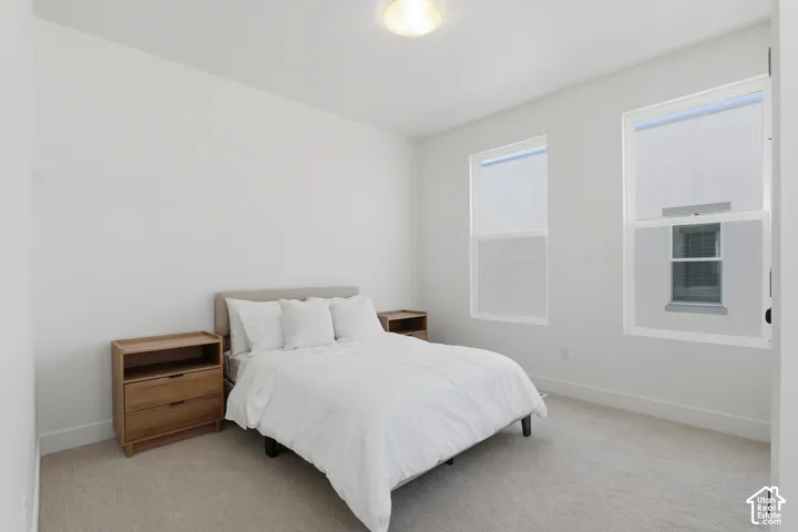 Light-colored wall-to-wall carpeting throughout
