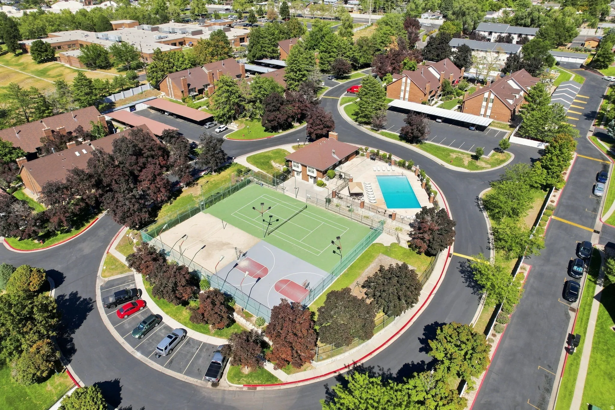 Central communal area featuring a tennis court, basketball court, and swimming pool