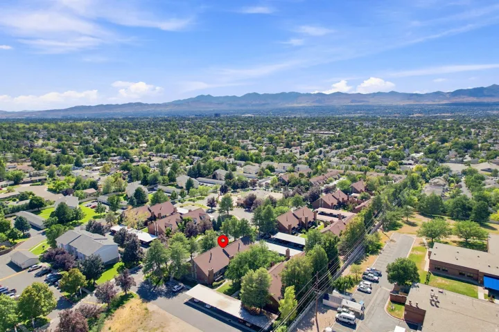 Residential community with expansive green landscaping and distant mountain scenery