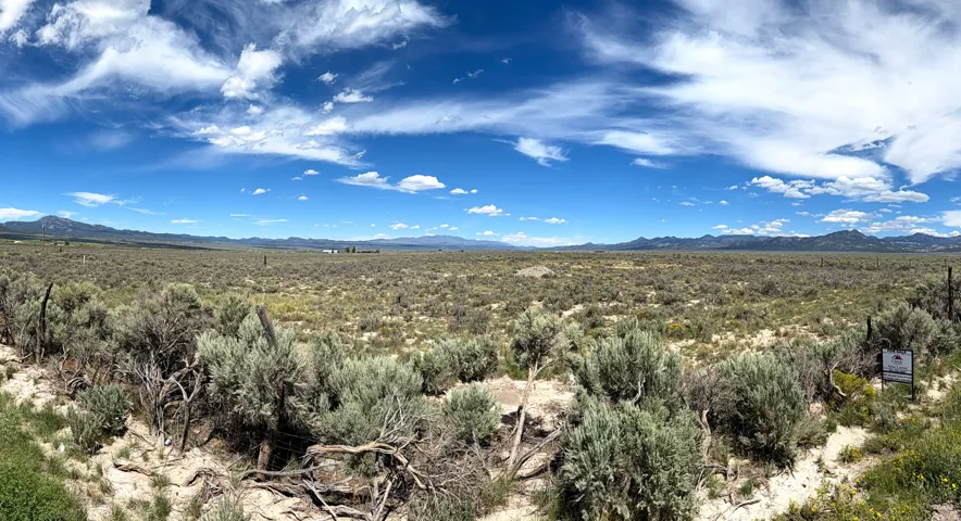 Expansive undeveloped land with a vast natural landscape and distant mountain ranges