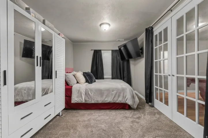 White French doors with clear glass panes with exterior walk-out door to garage