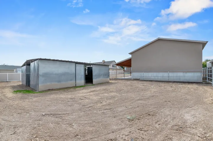 Side view of detached garage and  Barn/outbuilding with metal siding
