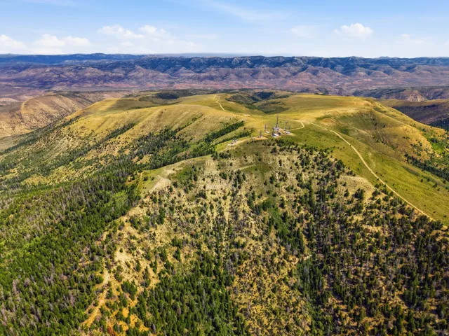 Expansive property featuring varied terrain, mature treelines, natural grasses, and established pathways