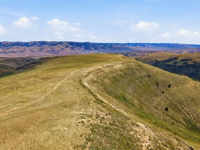 Expansive undeveloped land featuring natural terrain and distant mountains