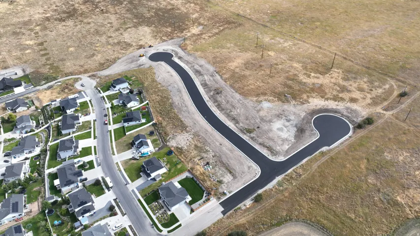 Newly constructed cul-de-sac with paved asphalt and concrete curbing