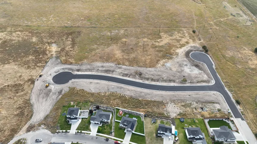 Newly paved cul-de-sac and street infrastructure with adjacent residential properties