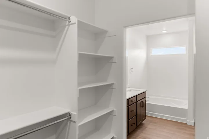 Walk-in closet with integrated shelving and hanging rods