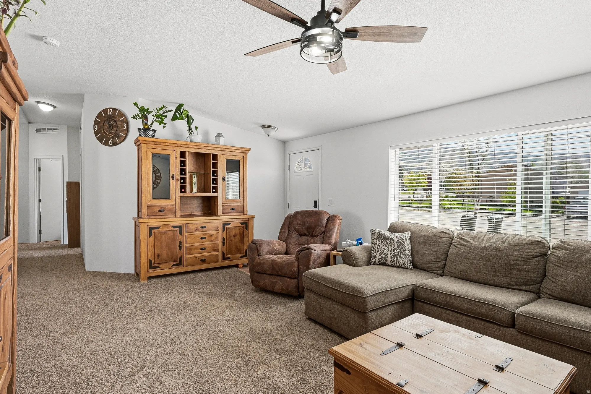 Ceiling fan with integrated lighting, recessed lighting, white walls, and a large window with blinds