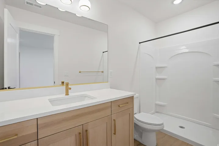 Vanity with integrated sink, gold-finish faucet, and coordinating cabinet hardware