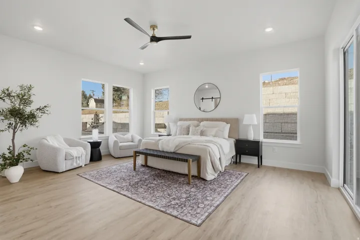 Recessed lighting, light wood-finish flooring, multiple windows, and a ceiling fan