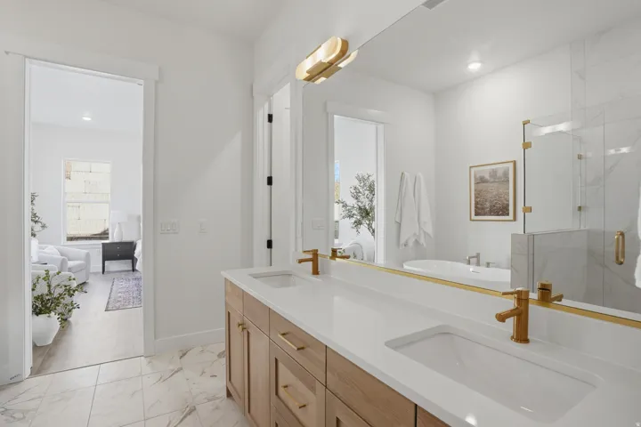 Dual vanity with wood-finish cabinetry and gold-tone hardware