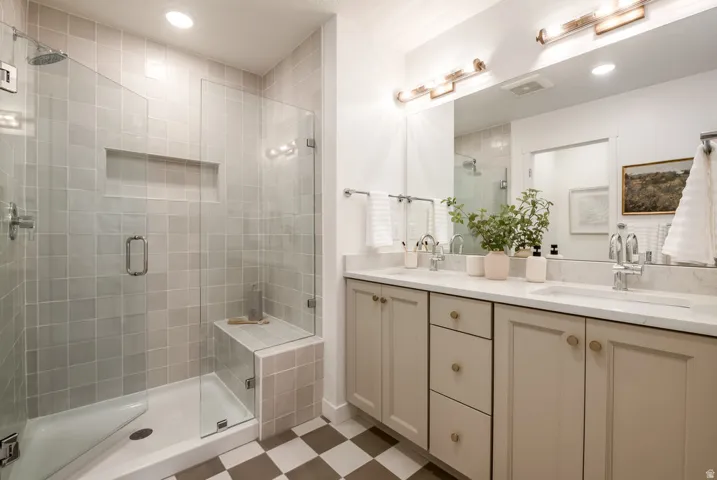 Shower with tiled walls, built-in niche, and integrated bench