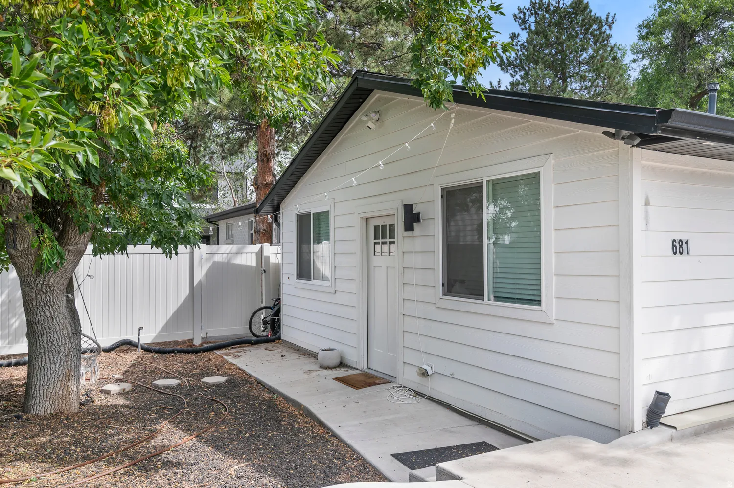 Unit #2White horizontal siding exterior with a black roof and white trim