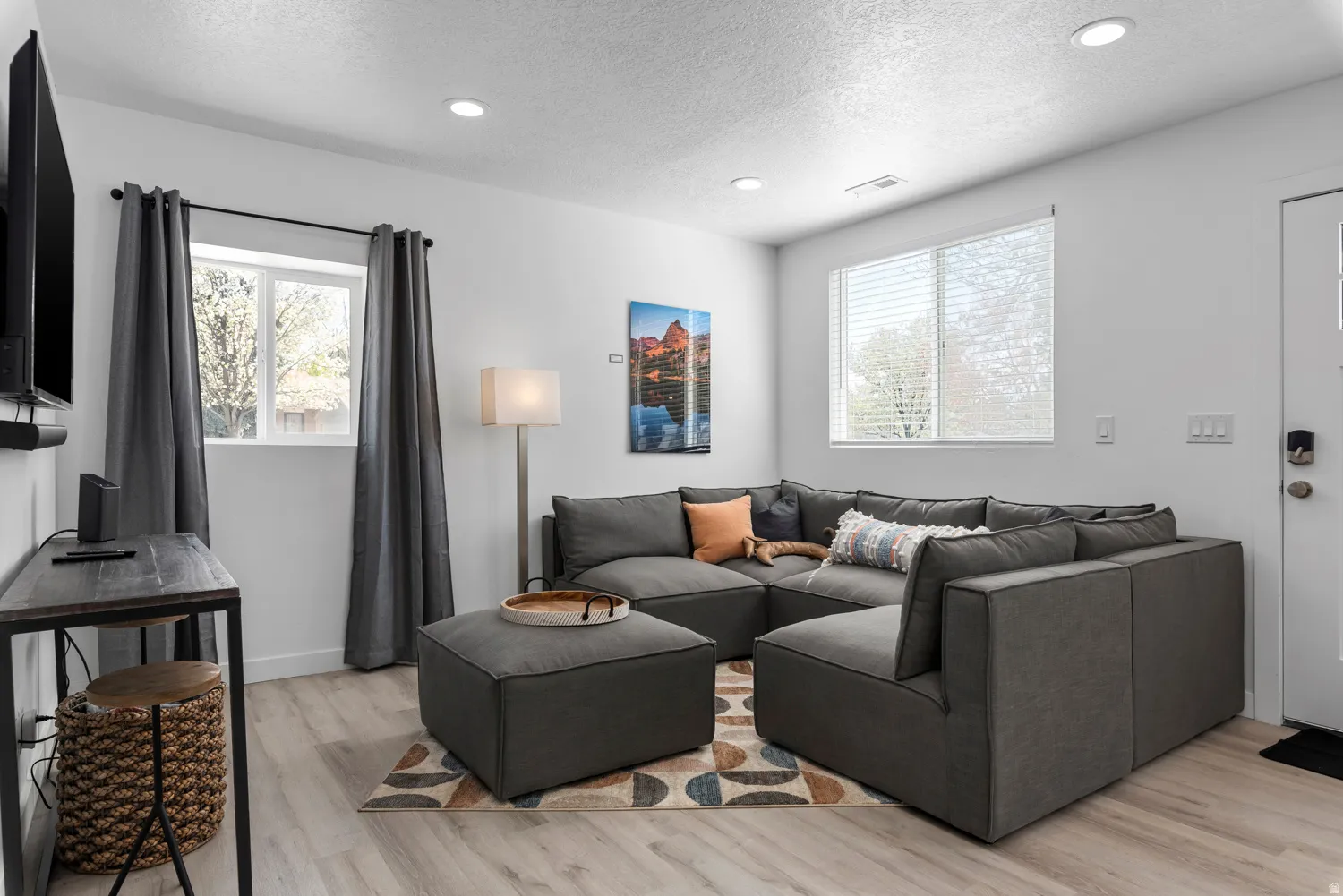 Unit #2Recessed ceiling lighting, wood-finish flooring, white walls, and multiple windows with blinds