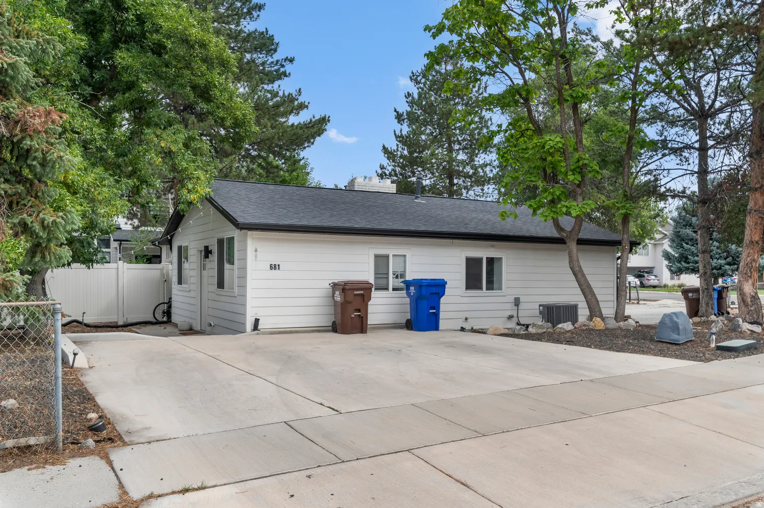 Unit #2 White siding exterior with a dark shingle roof