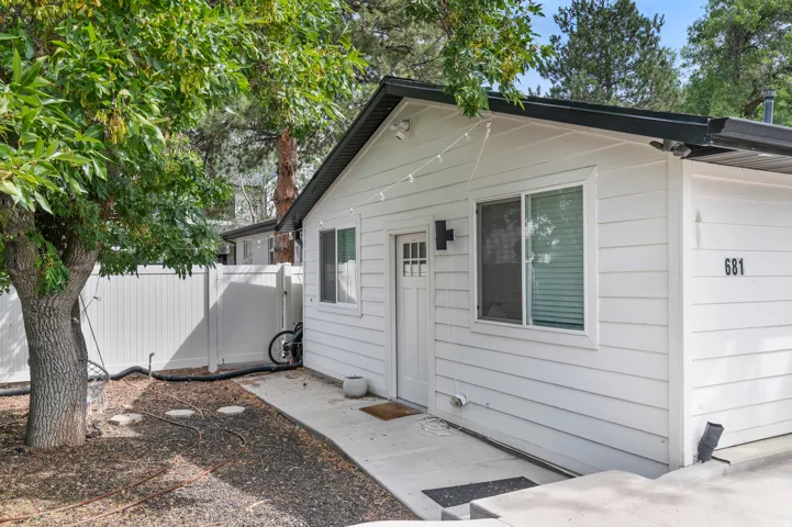 Unit #2White horizontal siding exterior with a black roof and white trim