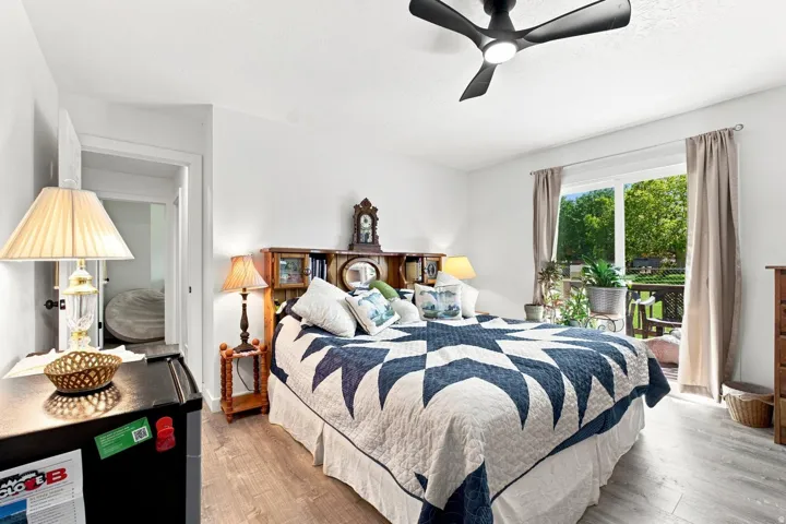 Recessed lighting, wood-finish flooring, and a contemporary ceiling fan