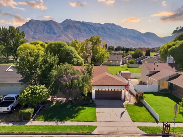 Single-story residence with an attached two-car garage, concrete driveway, and a manicured front lawn