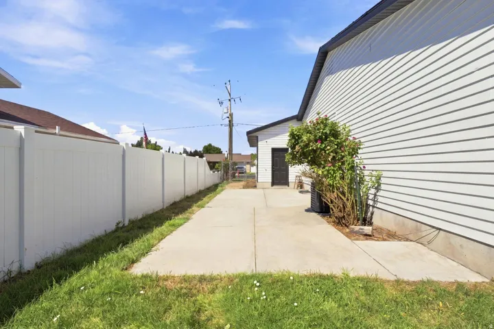 Concrete driveway with a vinyl fence