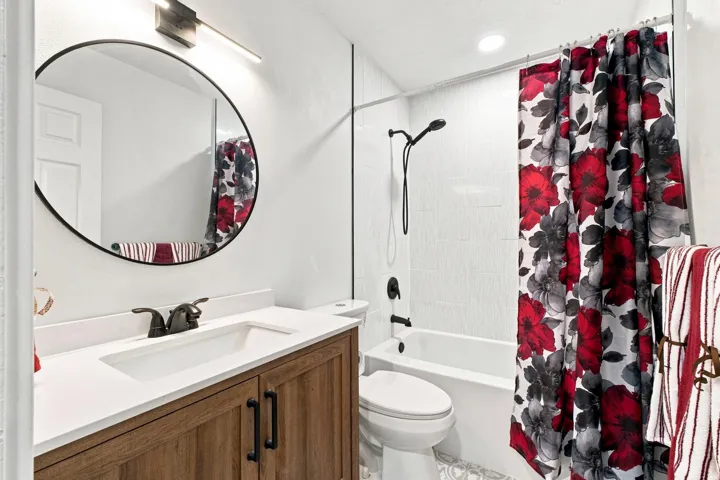 Wood-finish vanity with an integrated sink and bronze-finish faucet