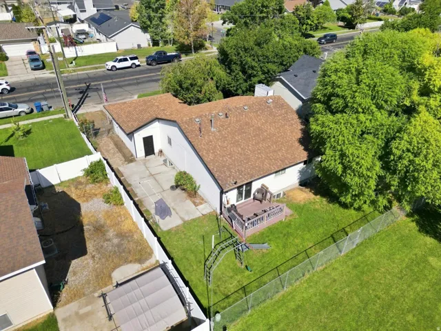 Asphalt shingle roof, rear wood deck, and chain link fencing