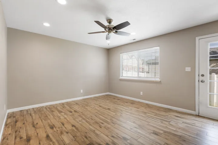 Wood-finish flooring, recessed lighting, and ceiling fan