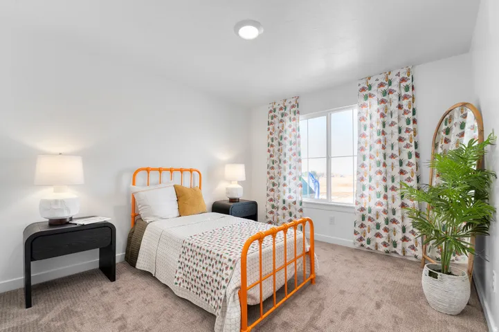 Recessed ceiling lighting, white walls, carpeted flooring, and a window with white trim