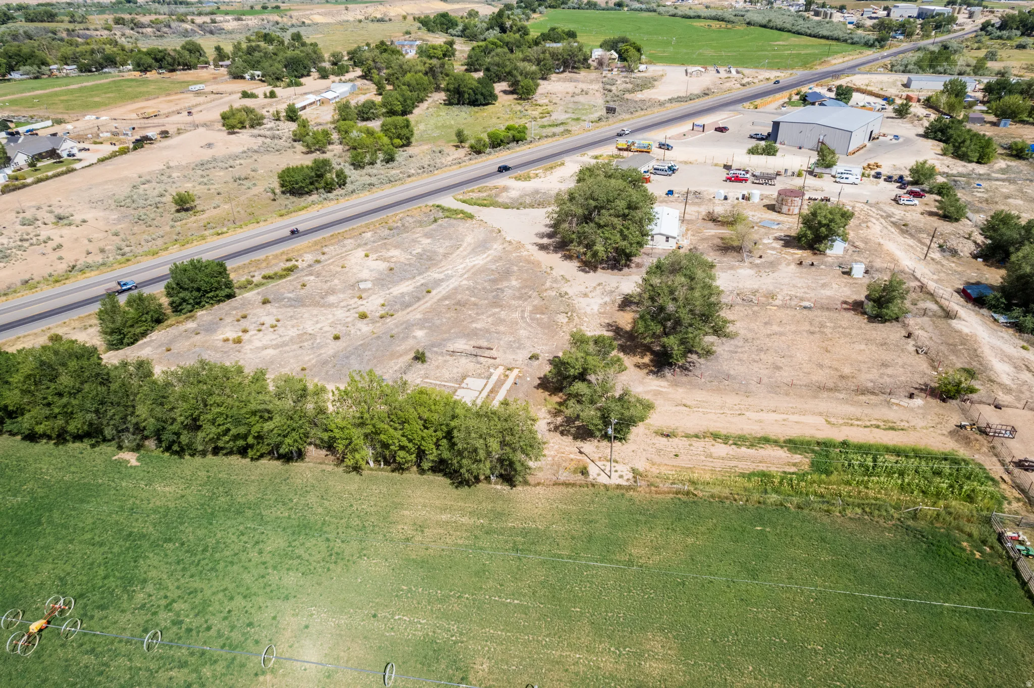 Expansive land parcel with direct road frontage and established trees
