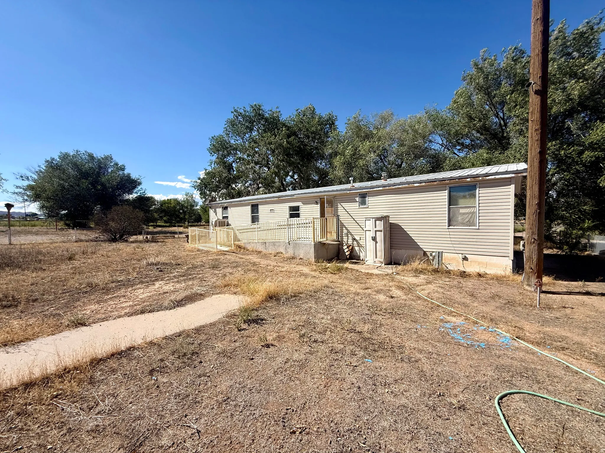 Siding exterior, metal roof, and an exterior ramp entry