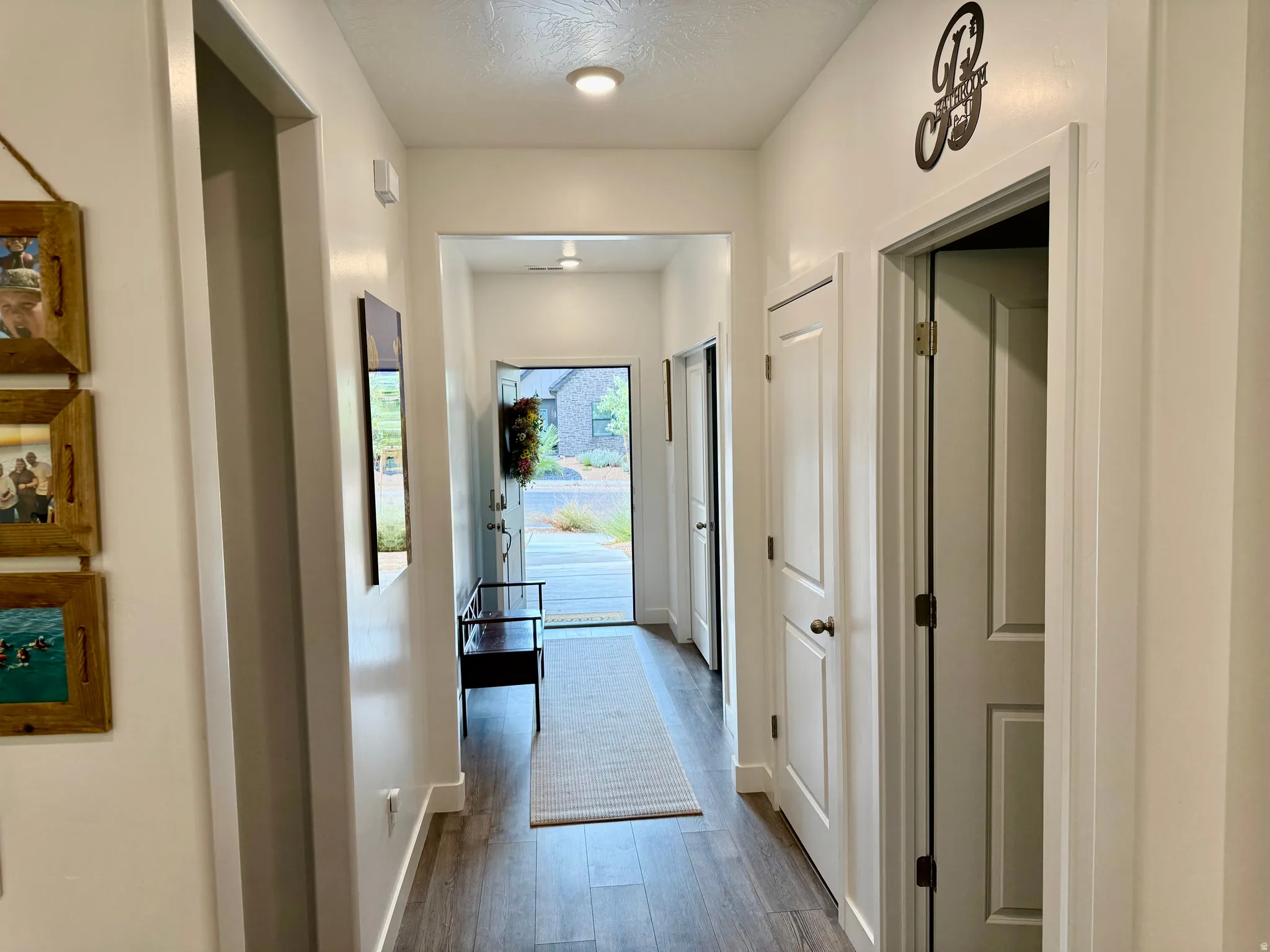 Entryway featuring wood-finish flooring, recessed lighting, and white paneled interior doors