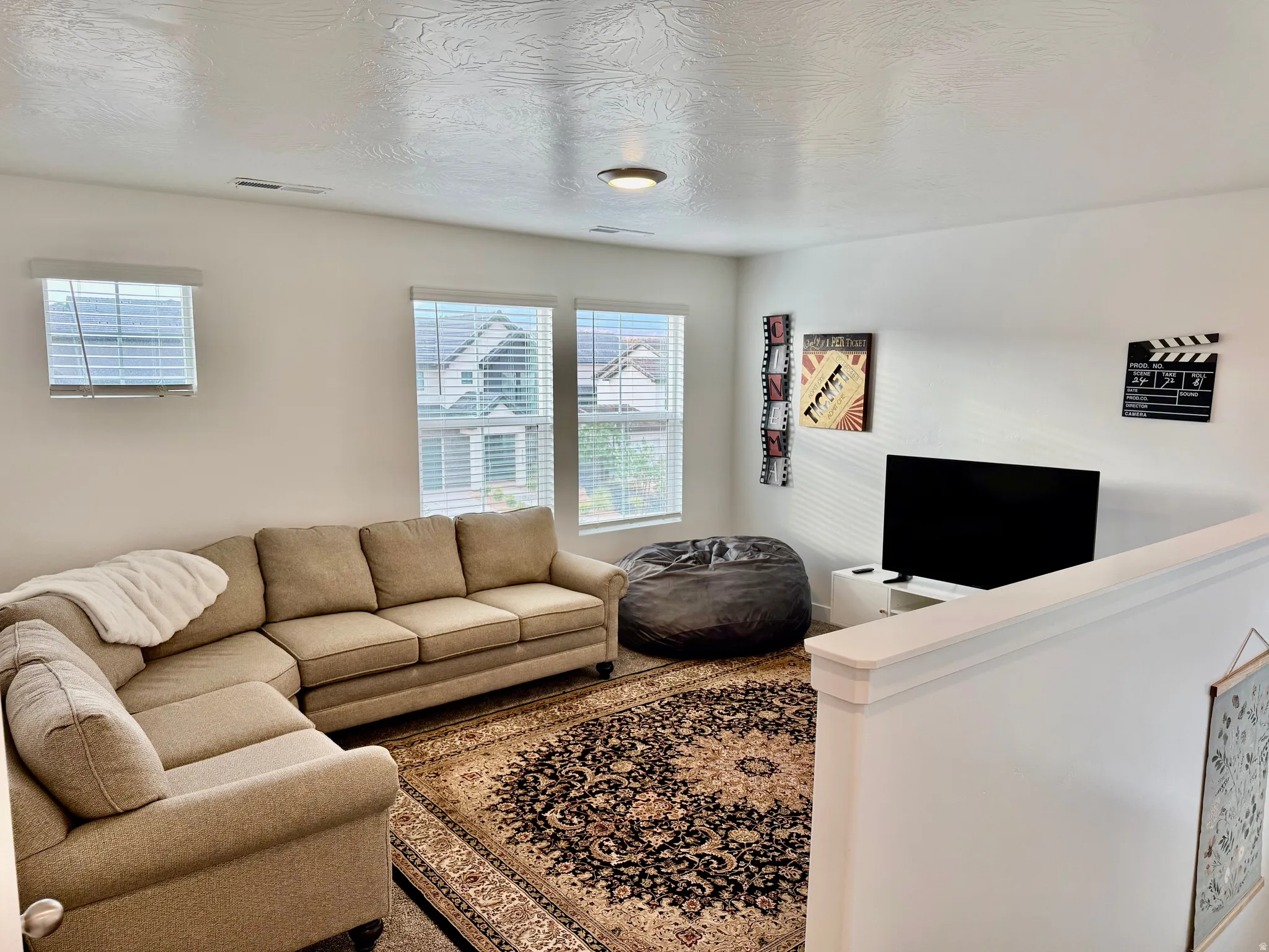 Bright interior space with multiple windows and a built-in half-wall partition