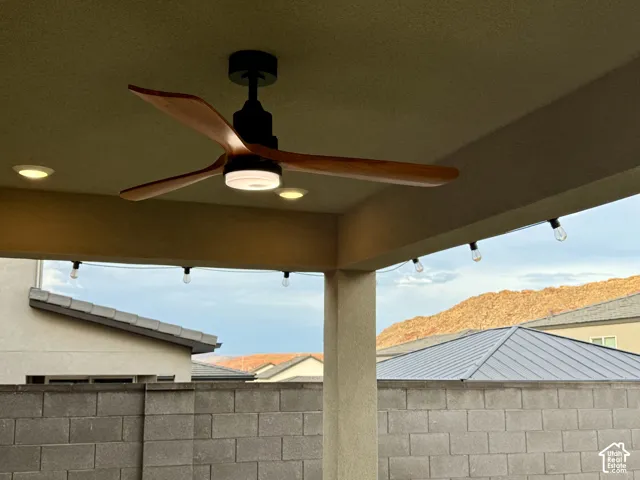 Covered patio featuring a wood-blade ceiling fan with integrated lighting, recessed ceiling lights, and string lighting