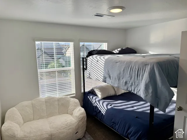 Bright interior space with dual windows, overhead flush-mount lighting, and white horizontal blinds