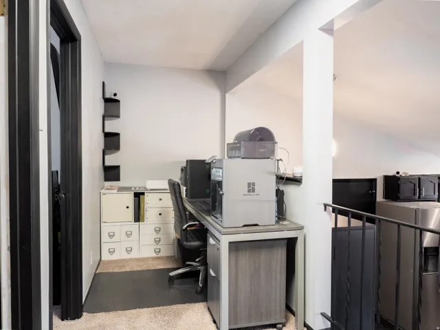 Carpeted flooring, built-in shelving, painted walls, and an open-concept design