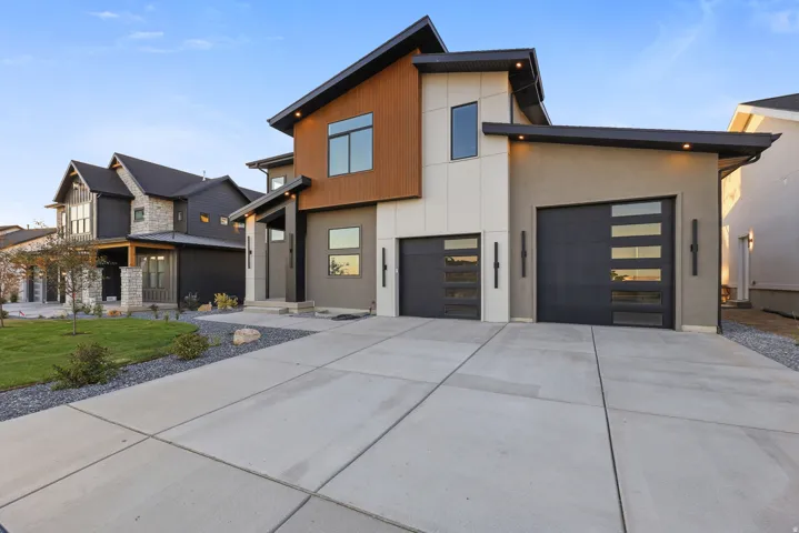 Modern exterior with a light stucco finish and wood panel accents