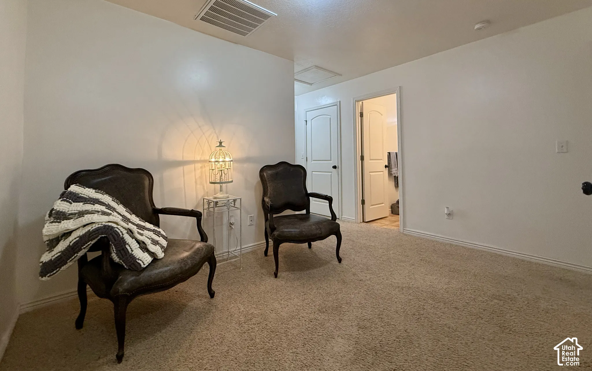 Recessed lighting, light neutral wall color, and light-colored carpeting