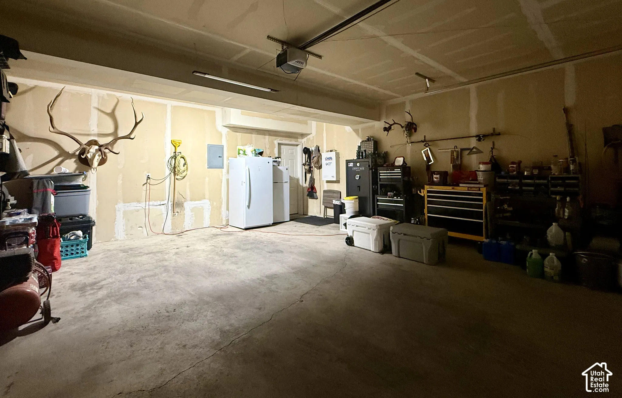 Spacious garage featuring concrete flooring and exposed drywall