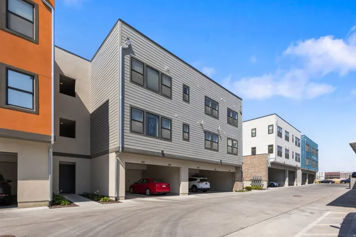 Multi-story property featuring horizontal siding and stucco exterior finishes