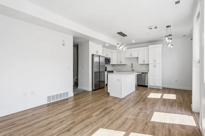 Open-concept living space with wood-finish flooring