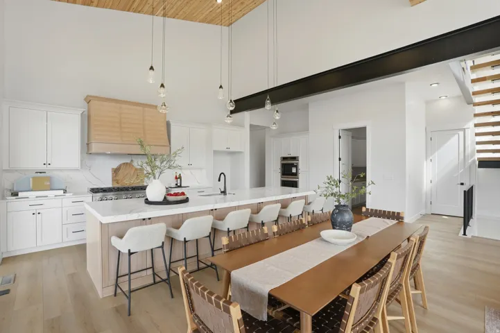 White shaker cabinetry with quartz countertops and a tiled backsplash
