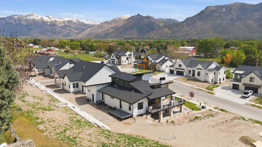 Modern architectural style featuring multiple gables, a balcony, and a two-car garage