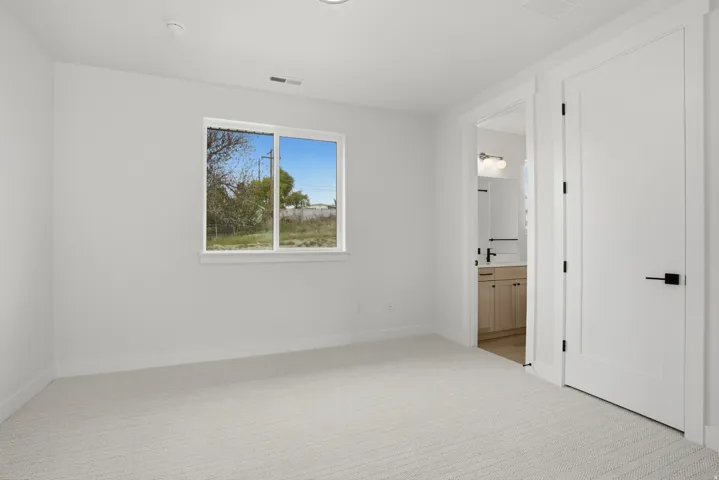 Light-toned carpeting, white walls, and white trim