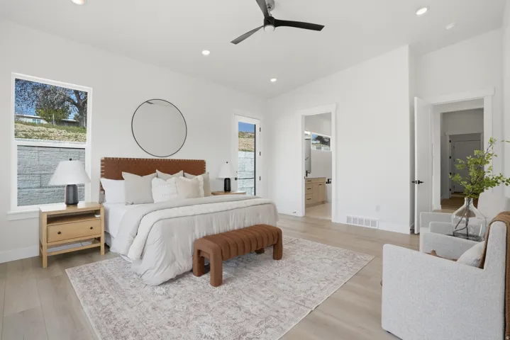 Recessed lighting, light wood-finish flooring, and white walls