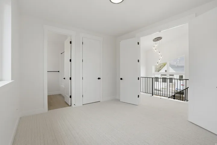 White walls and neutral carpet flooring