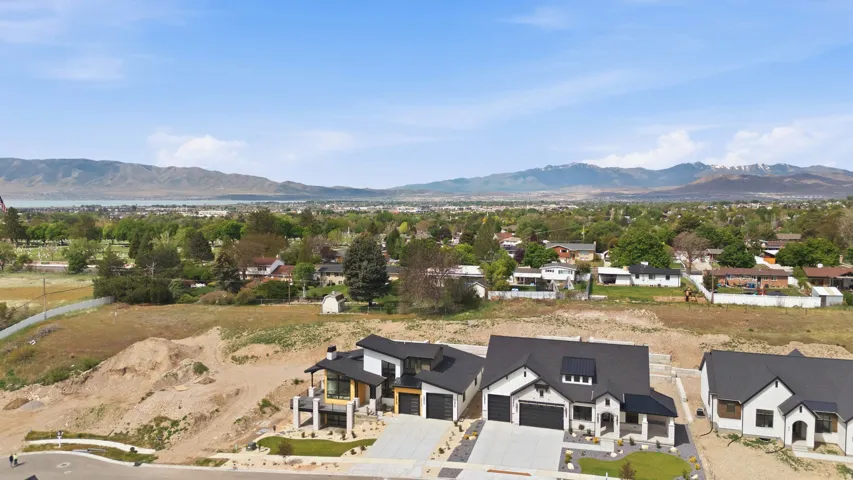 Modern architectural design, asphalt shingle roofing, integrated garage, concrete driveway, and landscaped front yard