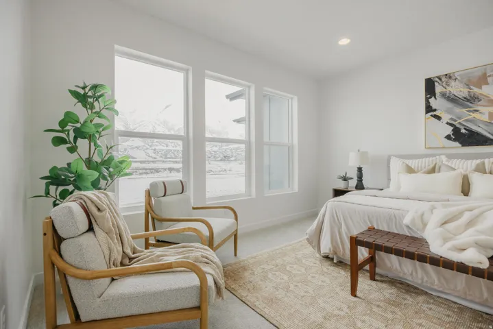 Bright interior with multiple large windows, recessed ceiling lighting, and soft carpet flooring