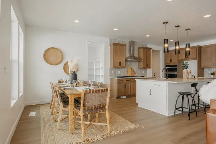 Open-concept design featuring wood-finish flooring, recessed lighting, and a kitchen island with pendant lighting