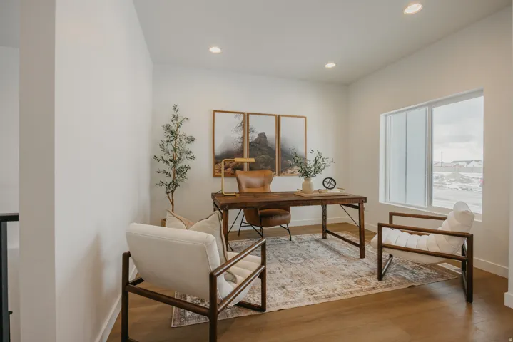 Wood-finish flooring, recessed lighting, and a large window provide abundant light