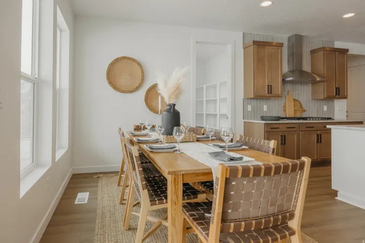 Open concept layout with wood-finish flooring, recessed lighting, and large windows