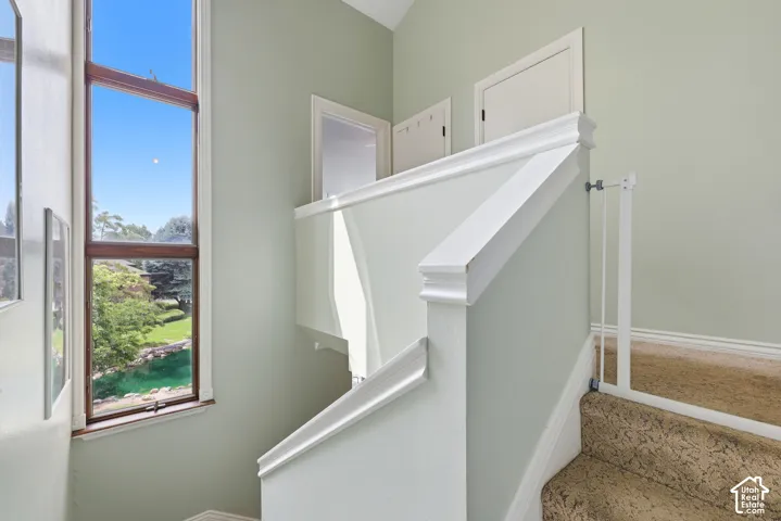 Floor-to-ceiling window with wood trim, offering a natural outdoor landscape